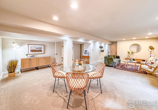 dining room with light colored carpet, baseboards, and recessed lighting