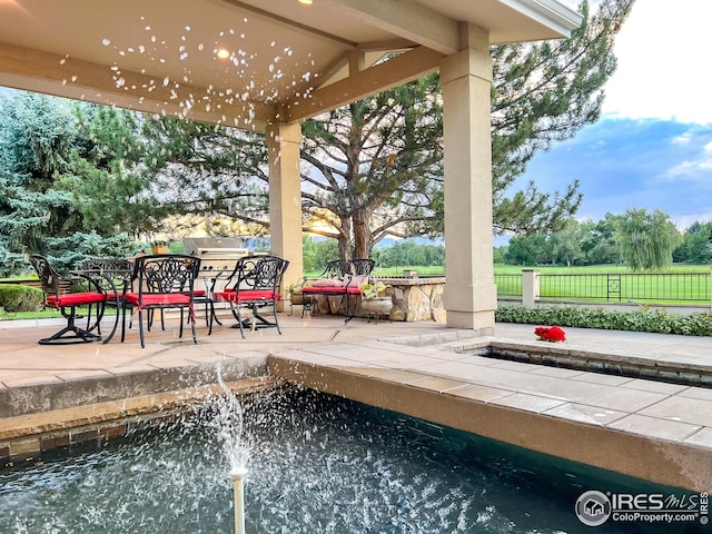 view of patio with fence and outdoor dining space