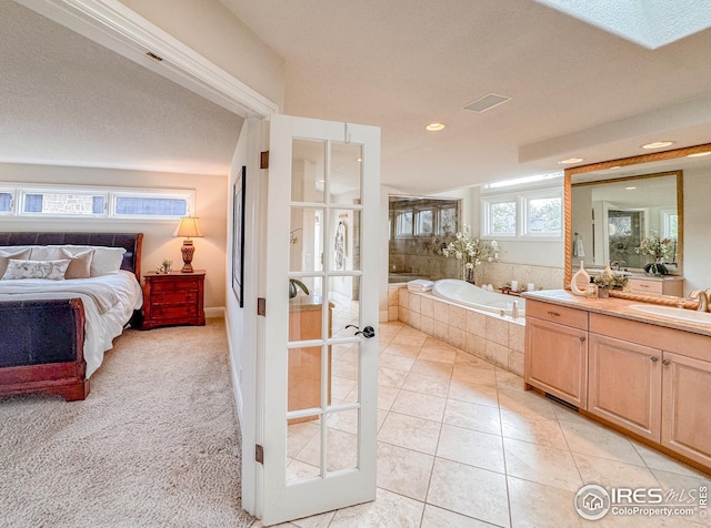 bathroom featuring a garden tub, tile patterned floors, recessed lighting, connected bathroom, and vanity