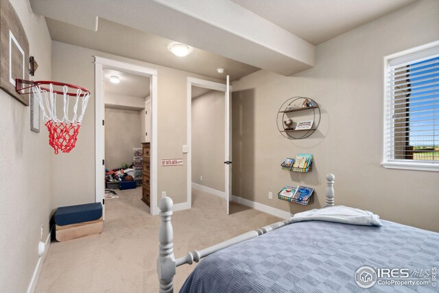 carpeted bedroom featuring baseboards