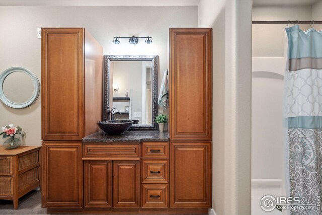 bathroom with curtained shower and vanity