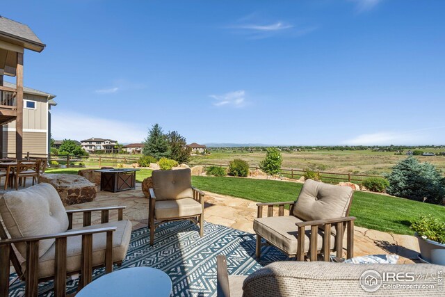 view of patio with outdoor lounge area and a rural view