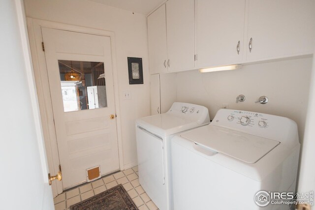 laundry area featuring separate washer and dryer and cabinet space