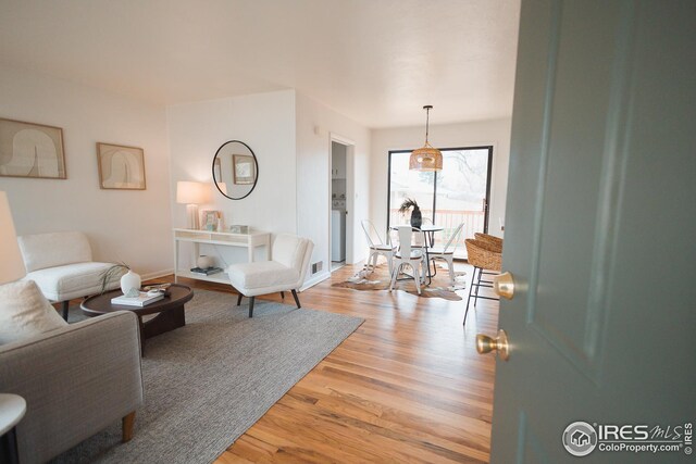 living room with baseboards and light wood finished floors