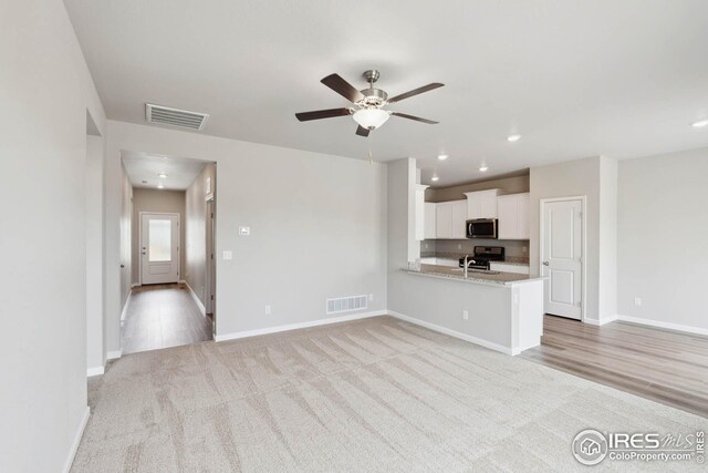 954 Cascade Falls St, Severance, CO 80550 - unfurnished living room with light carpet, ceiling fan, and recessed lighting