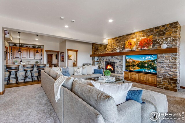 3865 Valley Crest Dr, Timnath, CO 80547 - living area featuring carpet flooring, a stone fireplace, and recessed lighting