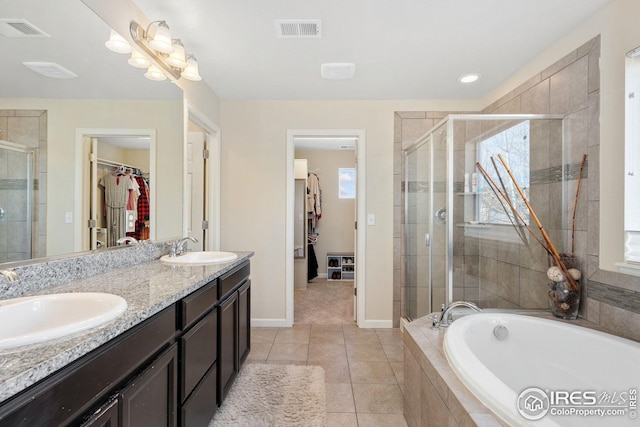 bathroom featuring a sink, a stall shower, and visible vents