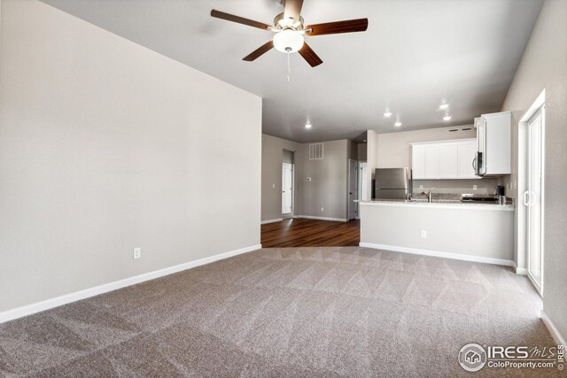 unfurnished living room with recessed lighting, baseboards, visible vents, light carpet, and ceiling fan