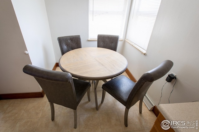 dining room with light tile patterned floors and baseboards
