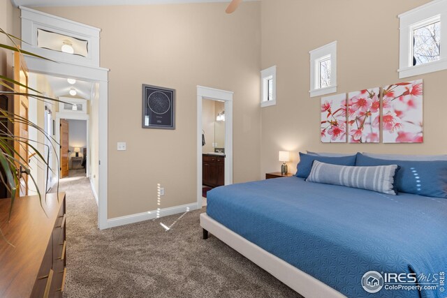 1016 Katy Ln, Longmont, CO 80504 - bedroom with baseboards, carpet flooring, a towering ceiling, and ensuite bathroom