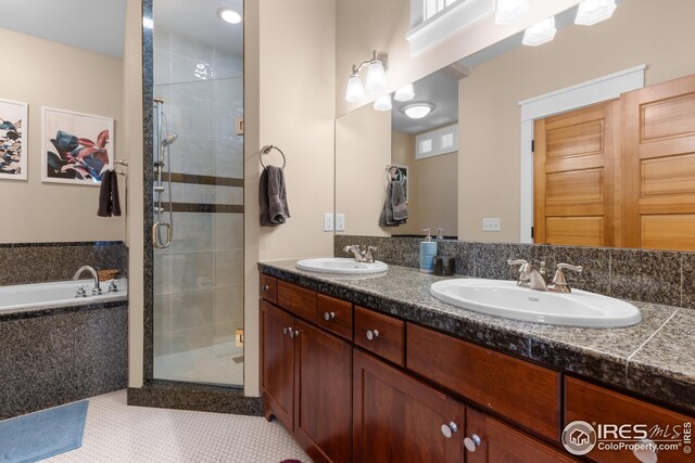 1016 Katy Ln, Longmont, CO 80504 - full bathroom featuring a stall shower, double vanity, a bath, and a sink