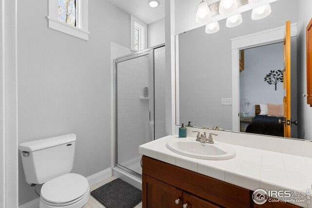 1016 Katy Ln, Longmont, CO 80504 - bathroom with toilet, vanity, ensuite bathroom, and a shower stall