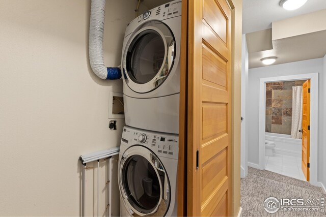 1016 Katy Ln, Longmont, CO 80504 - laundry area featuring stacked washer and dryer, laundry area, and tile patterned floors