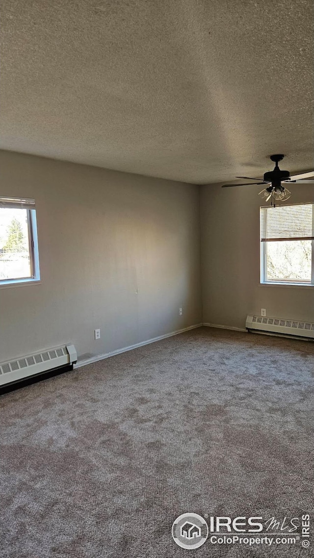 3328 Mcconnell Dr, Laporte, CO 80535 - empty room with a baseboard radiator, a ceiling fan, and dark colored carpet