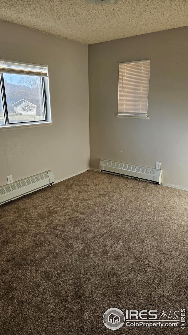 3328 Mcconnell Dr, Laporte, CO 80535 - carpeted empty room with a baseboard heating unit and a textured ceiling