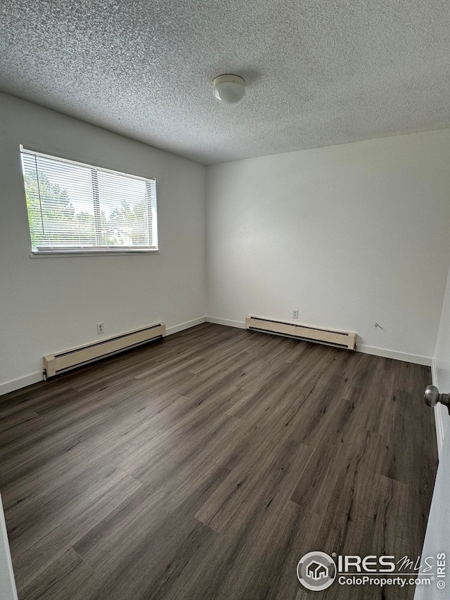 3328 Mcconnell Dr, Laporte, CO 80535 - unfurnished room featuring dark wood-style flooring, a textured ceiling, baseboards, and baseboard heating