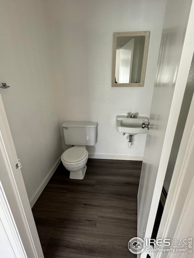 3328 Mcconnell Dr, Laporte, CO 80535 - bathroom featuring baseboards, wood finished floors, toilet, and a sink