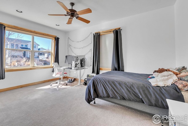 bedroom featuring baseboards, a ceiling fan, and carpet flooring