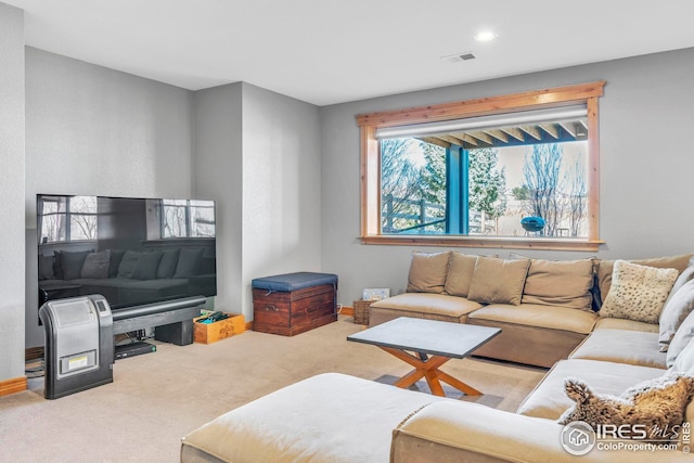 living room with visible vents, recessed lighting, and carpet flooring