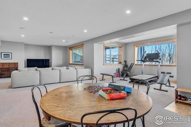 dining space with recessed lighting and carpet