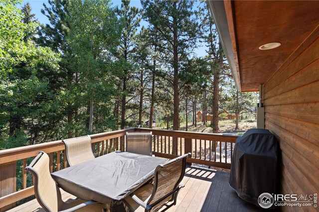 wooden terrace with outdoor dining space