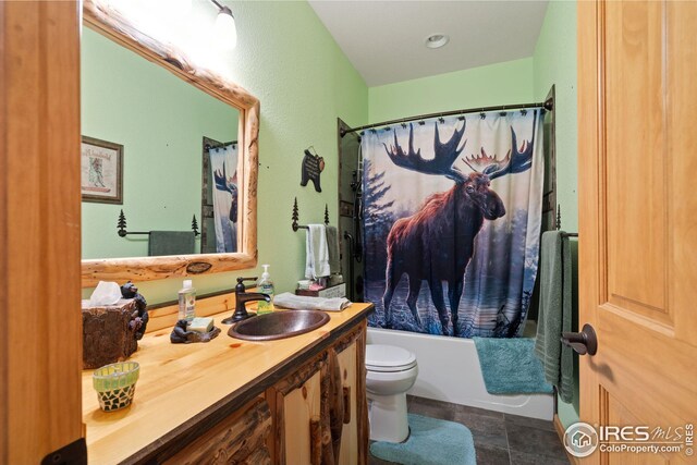 full bath featuring toilet, vanity, tile patterned floors, and shower / bathtub combination with curtain