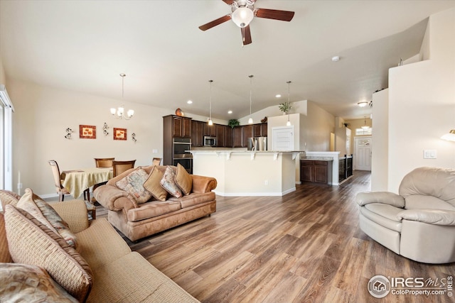 living area with vaulted ceiling, wood finished floors, baseboards, ceiling fan with notable chandelier, and recessed lighting