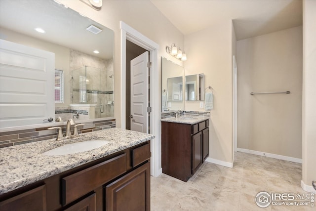 bathroom with visible vents, a sink, a stall shower, and two vanities