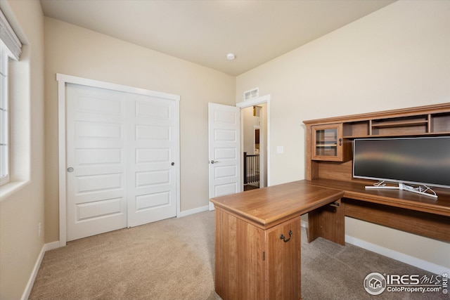 carpeted home office featuring baseboards and visible vents