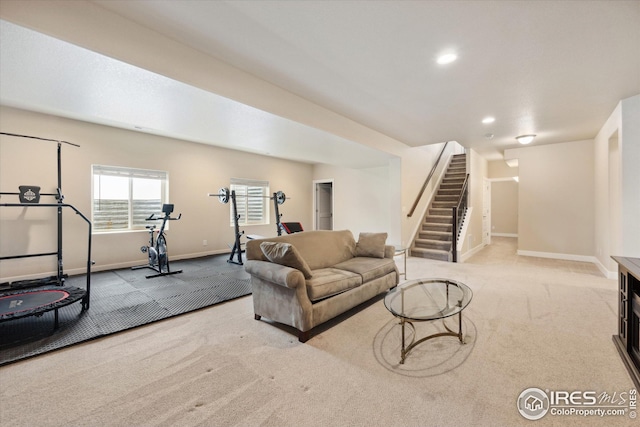 living area featuring carpet floors, baseboards, stairway, and recessed lighting