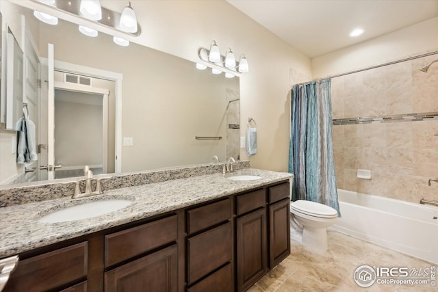 bathroom with visible vents, toilet, shower / tub combo with curtain, and a sink