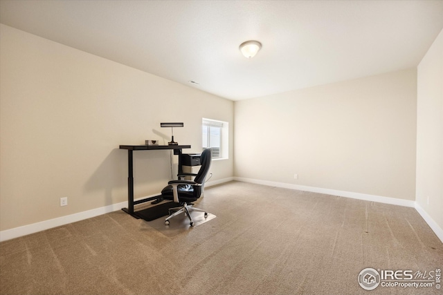 carpeted office space with baseboards