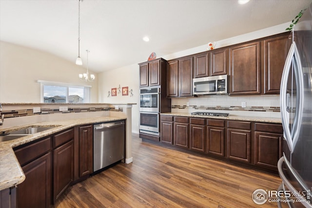 kitchen with backsplash, pendant lighting, an inviting chandelier, stainless steel appliances, and dark brown cabinets