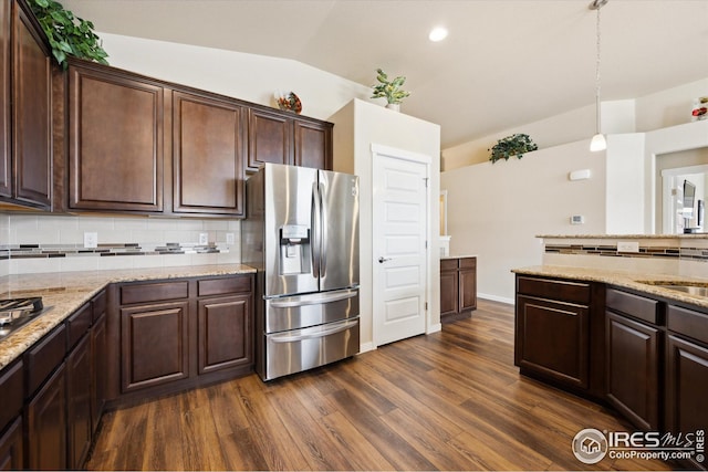 kitchen with vaulted ceiling, dark brown cabinetry, stainless steel fridge with ice dispenser, dark wood-style floors, and decorative backsplash
