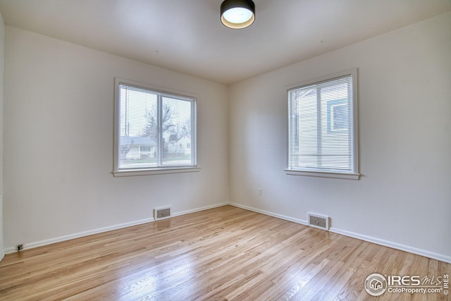 325 27th St, Boulder, CO 80305 - empty room with wood finished floors, baseboards, and visible vents