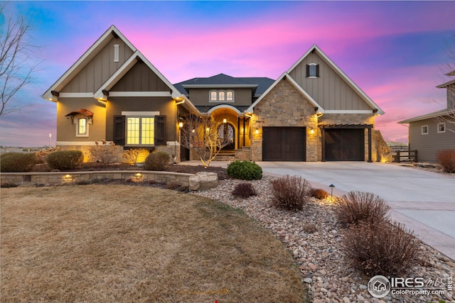 craftsman-style house featuring driveway, an attached garage, stone siding, and board and batten siding