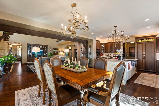 dining room featuring arched walkways, dark wood-style floors, a chandelier, and recessed lighting