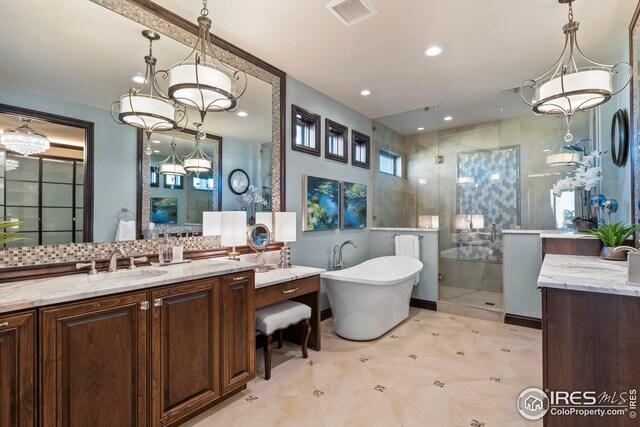 full bathroom with visible vents, a sink, a stall shower, and tasteful backsplash