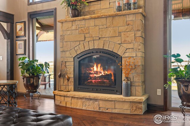 interior details featuring baseboards, a fireplace, and wood finished floors