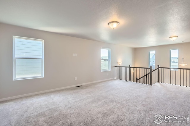 786 Griffith St, Lochbuie, CO 80603 - carpeted empty room with baseboards and a textured ceiling