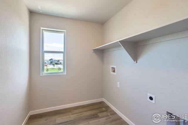786 Griffith St, Lochbuie, CO 80603 - washroom with hookup for a washing machine, wood finished floors, baseboards, and hookup for an electric dryer