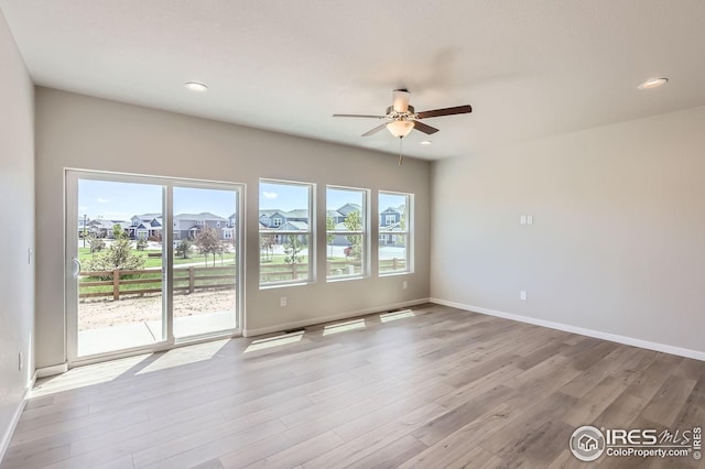 786 Griffith St, Lochbuie, CO 80603 - empty room featuring ceiling fan, wood finished floors, baseboards, a residential view, and recessed lighting