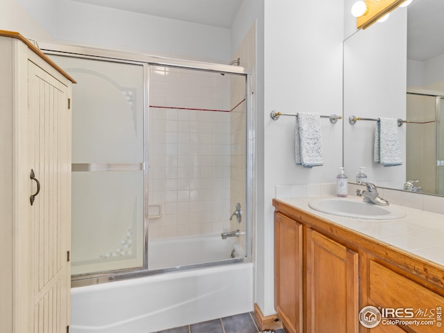 bathroom with vanity, bath / shower combo with glass door, and tile patterned flooring
