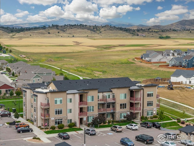 drone / aerial view featuring a residential view and a mountain view