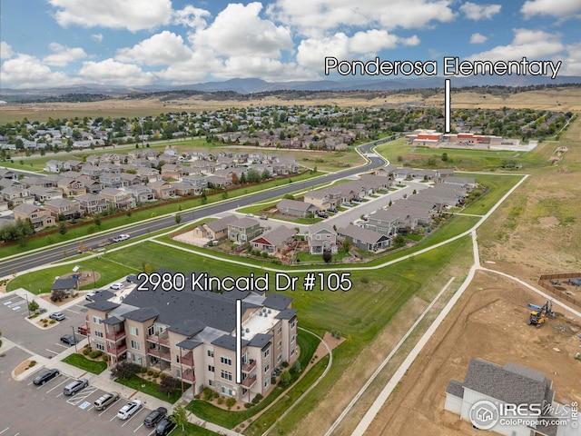 birds eye view of property with a mountain view and a residential view