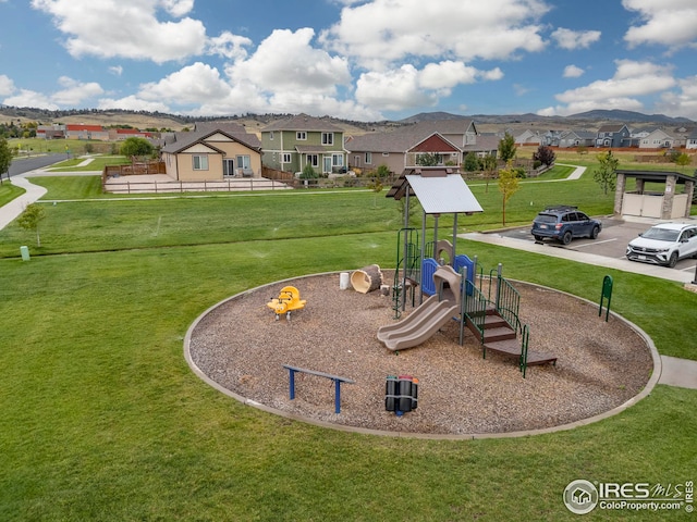 communal playground with a residential view and a lawn