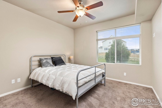 carpeted bedroom featuring baseboards and ceiling fan