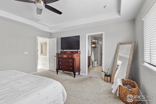 carpeted bedroom with baseboards, ensuite bathroom, and a ceiling fan