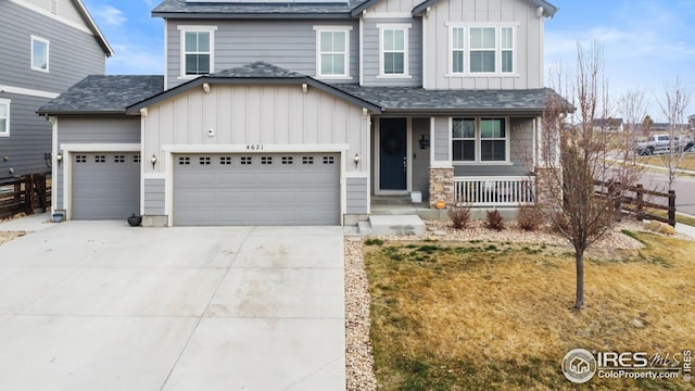 craftsman inspired home with board and batten siding, covered porch, a shingled roof, and driveway