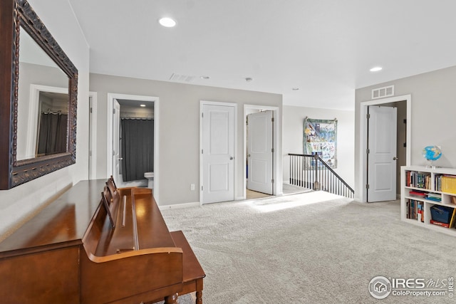 sitting room with carpet floors, recessed lighting, and baseboards